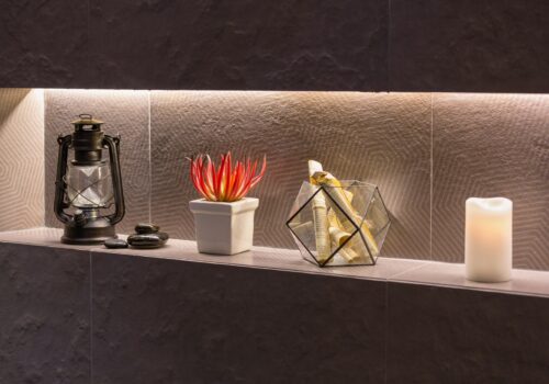 Shelf hole in a modern bathroom wall with decoration items.